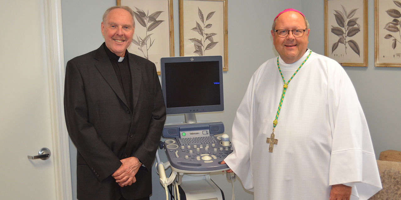 Ultrasound machine donated by St. Ladislas Knights of Columbus is blessed by bishop