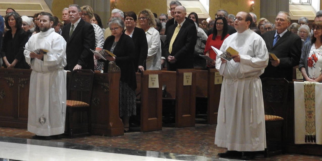 Two men ordained as transitional deacons on the path to priesthood