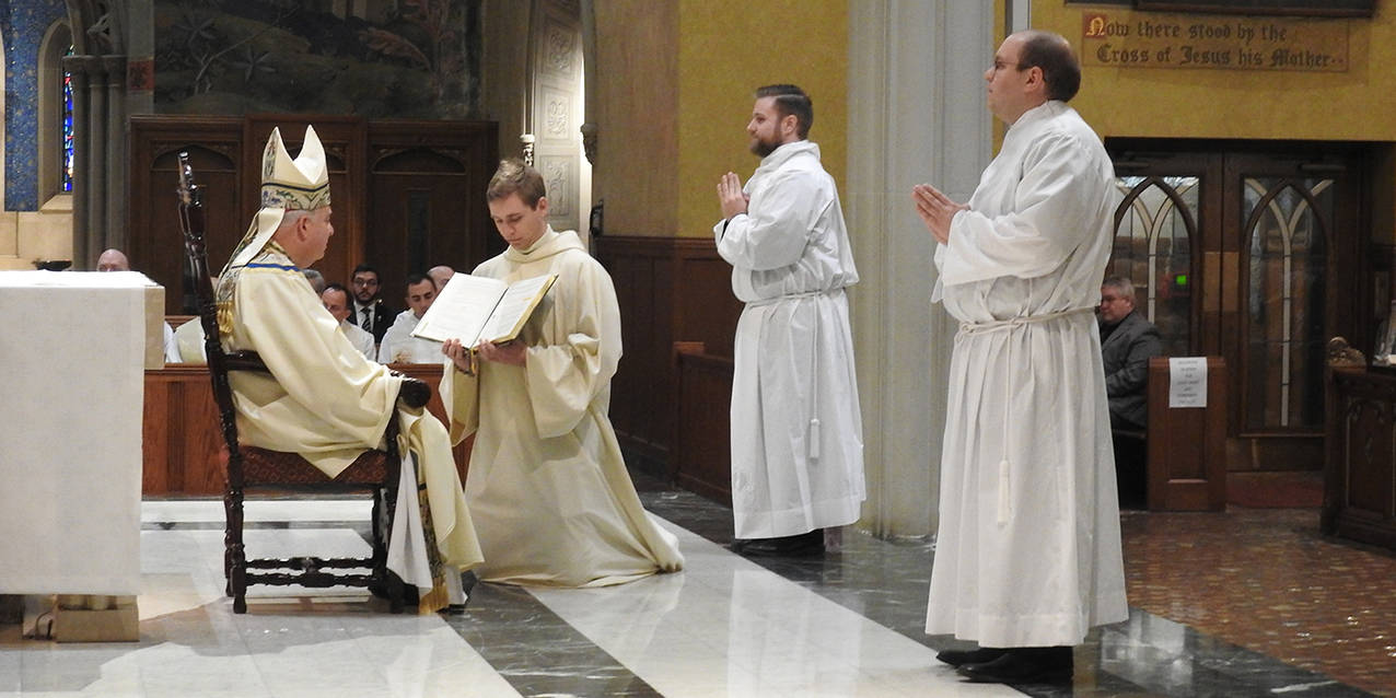 Two men ordained as transitional deacons on the path to priesthood