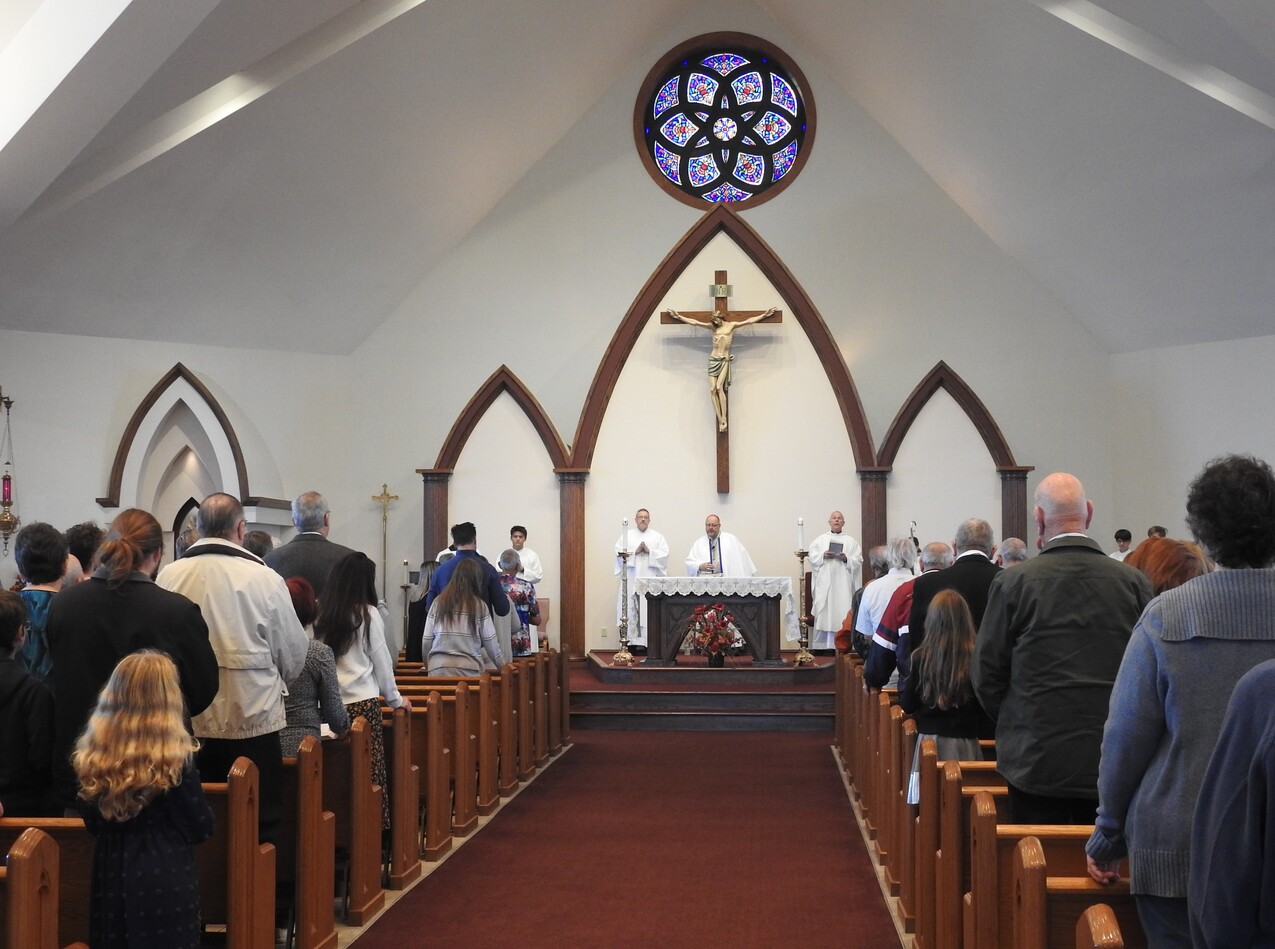 Mortgage burning highlights bishop’s visit to St. Martin of Tours, Valley City