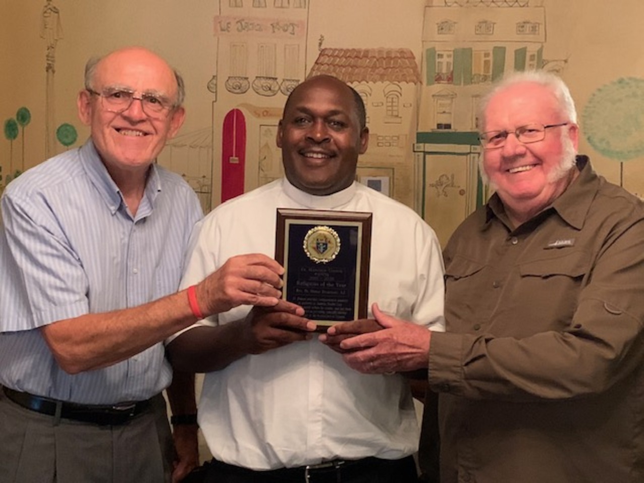 Knights of Columbus members surprise hospital chaplain with award 